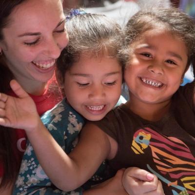 A volunteer and her students clap and sing songs during her teaching work experience in Costa Rica Happy children with their teacher at one of Projects Abroad's volunteer teaching placements in Costa Rica